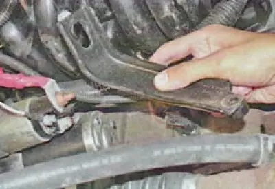 15. From the rear of the engine, unscrew the two nuts securing the spacer - to the intake pipe and…