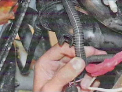 17. Remove the engine wiring harness from the holders on the intake manifold at the rear...