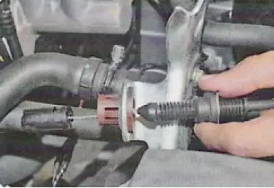 25. Remove the throttle cable end from the intermediate lever ball joint...