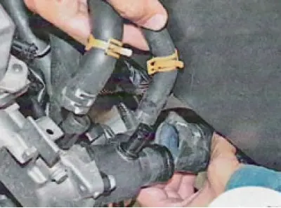 30. Loosen the clamps securing the three hoses and slide them along the hoses...