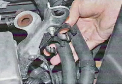 31. ...and disconnect the hoses from the thermostat and cylinder head pipes.
