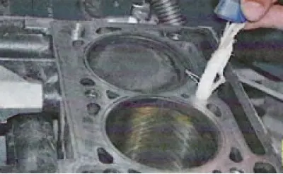 43. Check the cylinder head for warping. To do this, place the ruler edgewise on the surface of the…