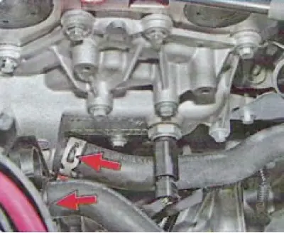 11. Loosen the clamps securing the two hoses, slide them along the hoses and disconnect the hoses…