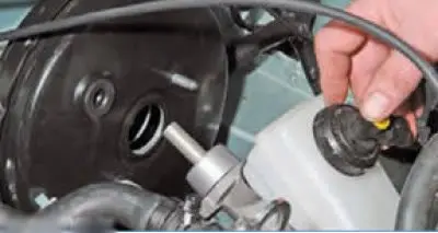 Carefully remove the brake cylinder assembly with the reservoir from the booster studs and set it…