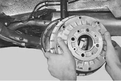 7. To check the degree of wear of the rear brake pads, remove the wheel and brake drum (see…