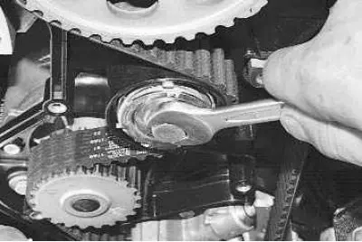 4. Loosen the tension roller mounting bolt with a 15 mm wrench and turn the tension roller to…