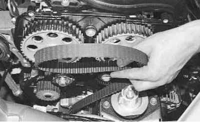 5. Remove the belt from the camshaft pulleys, tension roller and water pump toothed pulley.