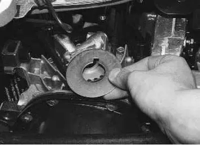 9. Remove the washer from the timing belt drive pulley.