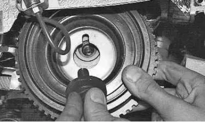 12. Install the camshaft drive belt in the reverse order of removal. The generator drive pulley is…