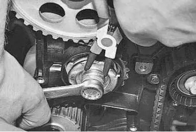 14. After installing the belt, adjust its tension. To do this, use a special key or a snap ring…