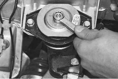 4. To replace the rear support cushion, use a 15 mm wrench to unscrew the nut securing the support…