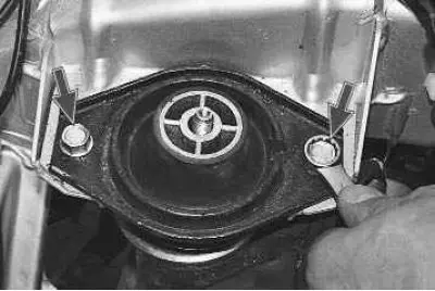 6. Using a 13 mm spanner, unscrew the two bolts securing the rear support cushion to the body...