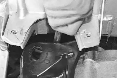 9. To replace the rear support bracket, use a 13 mm wrench to unscrew the two nuts securing the…