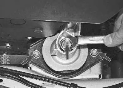 13. Using a 17 mm wrench, unscrew the nut securing the front support cushion to the bracket and use…