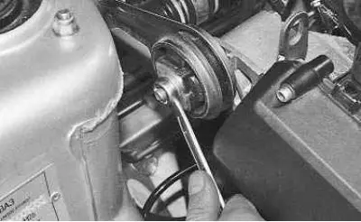 22. …use a 15 mm wrench to unscrew the nut securing the rod to the support bracket and remove the…