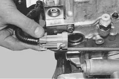 4. …and the injector wiring harness connector from the front bracket.