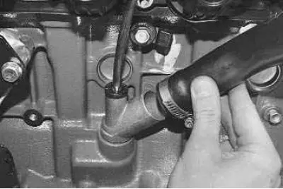 10. …and remove the crankcase ventilation system exhaust hose from the cylinder block pipe.