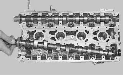 11. Remove the camshafts from the cylinder head supports.