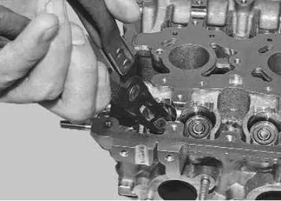 17. Press the valve stem seal off the valve guide.