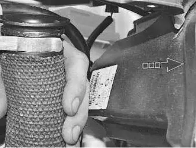 9. Remove the air intake hose tip from the bracket by pulling it towards the left headlight…