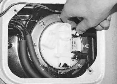 2. Squeeze the plastic retainer…