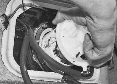 10. Remove the pump from the tank, tilting it to the side so as not to bend the fuel gauge sensor…