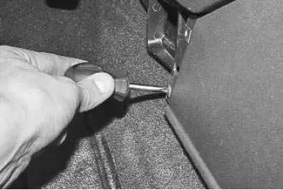 4. Remove the two screws securing the upper trim at the front (left and right).