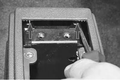 14. Remove the two screws securing the rear ashtray housing.