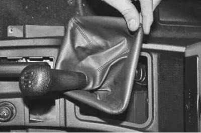 16. Remove the gear shift lever boot from the upper trim.