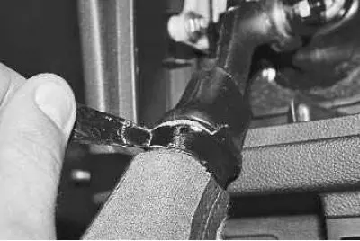 17. Turn the cover inside out and unwind the adhesive tape securing the cover to the gear shift…