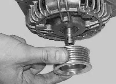 18. Remove the spring washer and pulley from the rotor shaft.