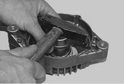 25. Press the new bearing into the cover using a socket head of the appropriate diameter.