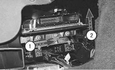 6. Move the bracket with the ECU to the right and, lifting it up a little, remove the ECU from the…