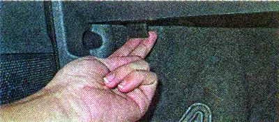 The hood lock handle is located under the instrument panel on the left side.