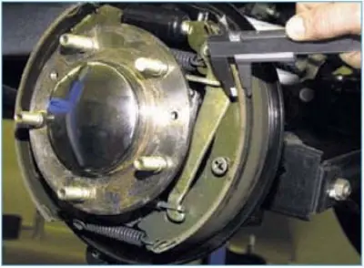 Through the window we assess the condition of the front brake shoe lining. If the lining thickness…