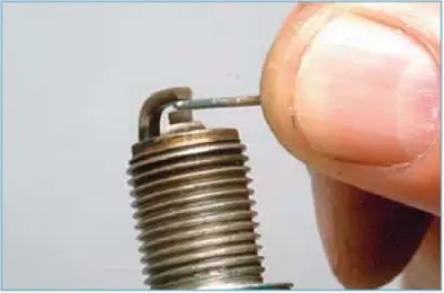 Using a high 21 mm socket with an extension or spark plug wrench, unscrew the spark plug and remove…